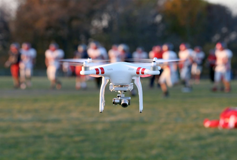 DJI Phantom drone being used to capture footage of football practice